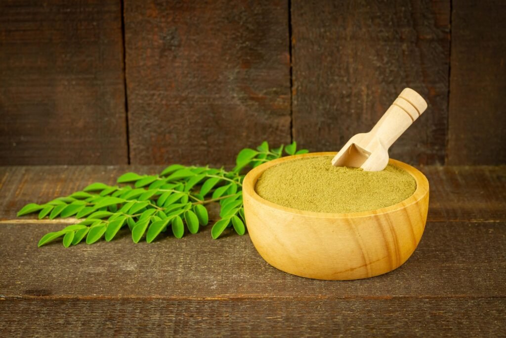 "Applying a moringa powder hair mask for natural hair growth at home"
